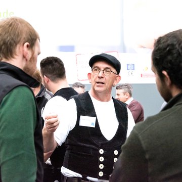 This photo shows tradespeople and other interested parties talking to each other at the pro clima stand at a trade fair