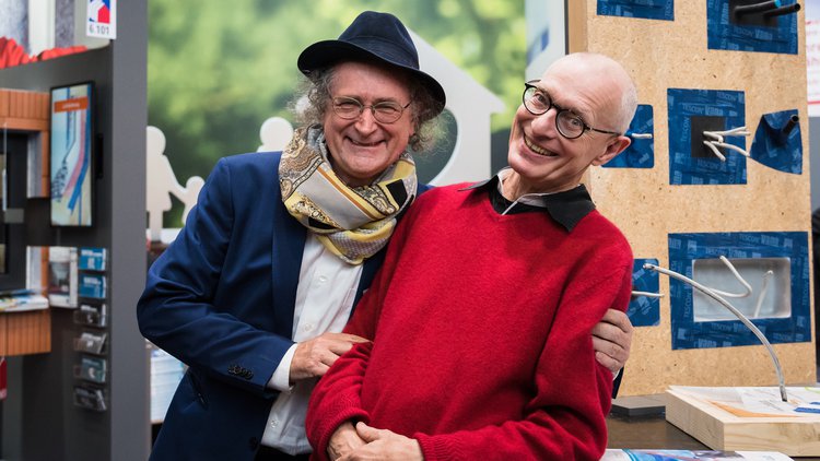 A photo showing the smiling company founders, Lothar and Uwe, taken at a trade fair.