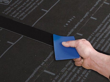 3. Rub the tape firmly to secure the adhesive bond