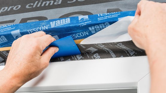 6. Stick the tape to the reveal all around the frame and rub to secure